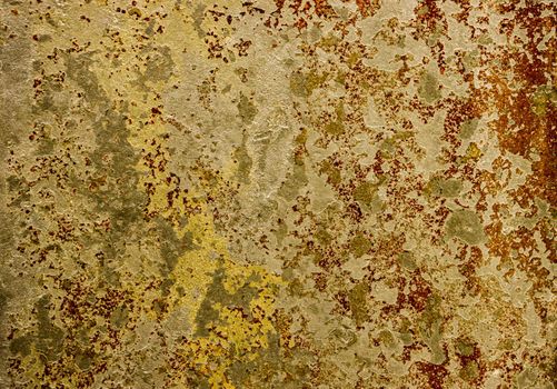 Old rusty metal surface with peeling paint. Peeling old yellow paint with elements of rust.