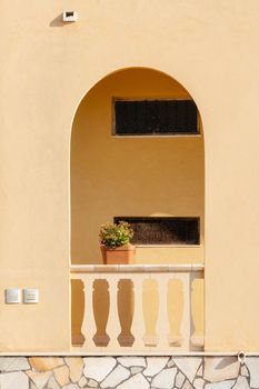 Typical yellow house facade part in italian city near the sea. Mediterranean village style architecture.