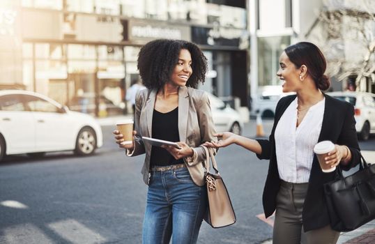 Making moves all around town. two businesswomen having a discussion while walking in the city
