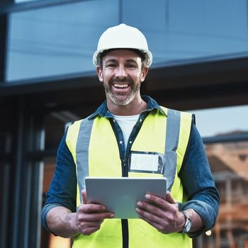 Technology is changing architecture. a engineer using a digital tablet on a construction site