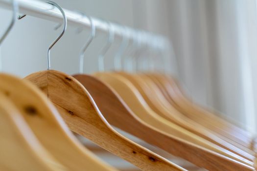 Close-up of wardrobe with wooden clothes hanger