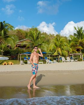 young men in a swim short on vacation in Saint Lucia, luxury holiday Saint Lucia Caribbean, men and woman on vacation at the tropical Island of Saint Lucia Caribbean. Calabash beach St Lucia Caribbean