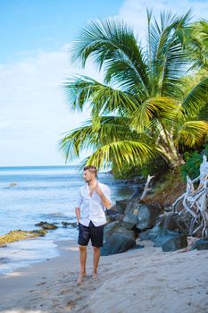 young men in a swim short on vacation in Saint Lucia, luxury holiday Saint Lucia Caribbean, men and woman on vacation at the tropical Island of Saint Lucia Caribbean. Calabash beach St Lucia Caribbean