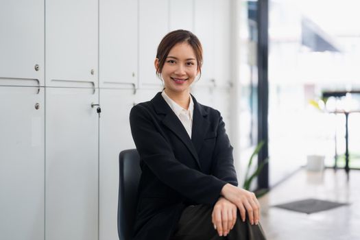 Portrait of smiling confident aisan female in office.