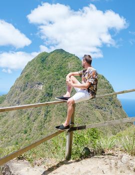 Men hiking in the mountains of Saint Lucia Caribbean, nature trail in the jungle of Saint Lucia with a look at the huge Pitons.