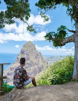 Men hiking in the mountains of Saint Lucia Caribbean, nature trail in the jungle of Saint Lucia with a look at the huge Pitons.