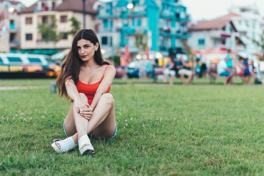 Girl relaxing on the lawn in a city park