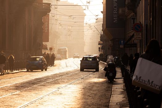 Milan, Italy - January 23, 2022: Pedestrians and cars on Corso Porta Venezia district of Milan. The street is a major fashion shopping street on January 23, 2022