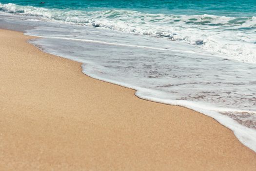 Deserted beach Sea waves overlook the sandy shore Summer background