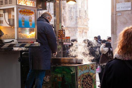 Milan, Italy - January 23, 2022: A street vendor sells freshly roasted chestnuts typical Italian street food on January 23, 2022