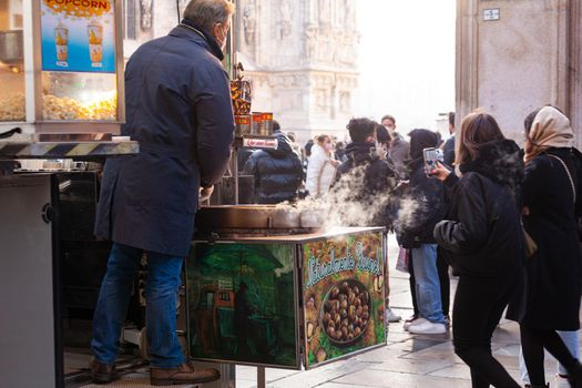 Milan, Italy - January 23, 2022: A street vendor sells freshly roasted chestnuts typical Italian street food on January 23, 2022