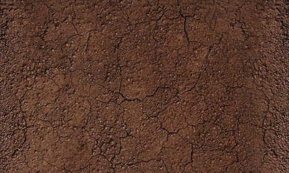 Dark soil texture closeup of dry soil background