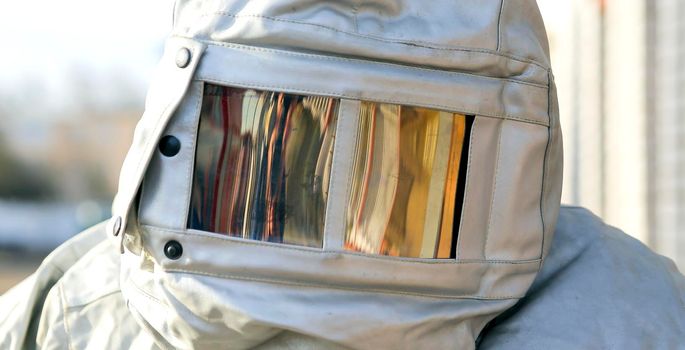 Firefighter training. The overalls are heat-resistant. Helmet close-up, protective glass with a reflective effect.