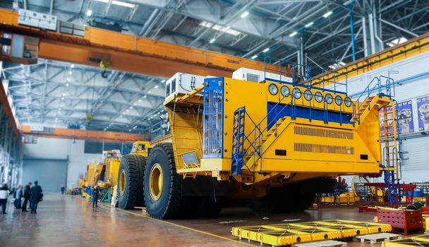 The plant houses heavy mining dump trucks. Plant for the production of heavy mining dump trucks, car assembly workshop.