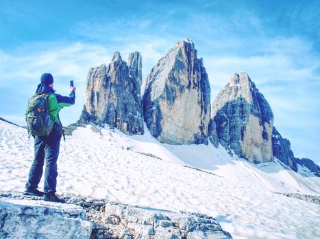 Traveler Man enjoying serene view Tre Cime mountains and landscape. Travel Lifestyle hiking concept summer vacations outdoor