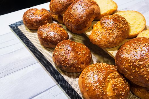 freshly baked buns cut to make pulled pork hamburger