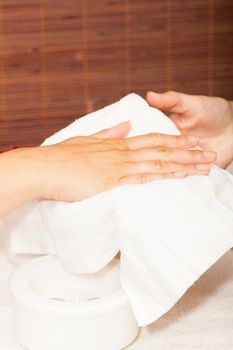 Preparing a woman's hands for a manicure