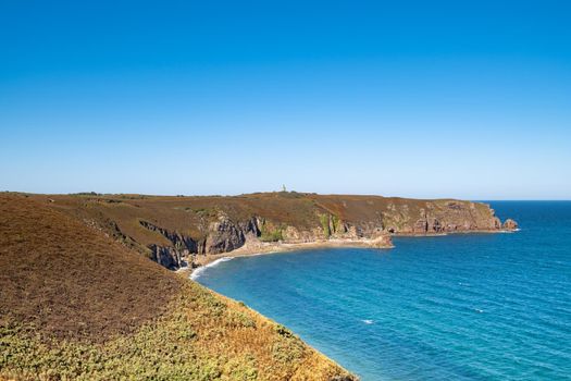 ride on the GR34 in Brittany with far off Cape Frehel and its lighthouse