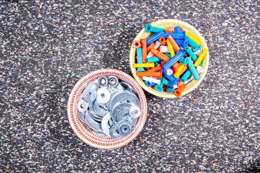 assortments of dowels and screws in small bowls.