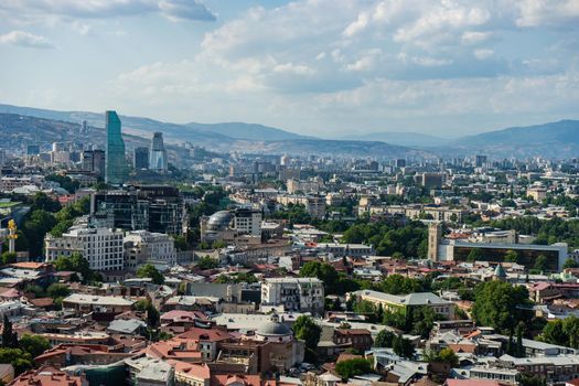 Tbilisi's cityscape with overview of Old town medieval architecture and Downtown with modern skyscarpers