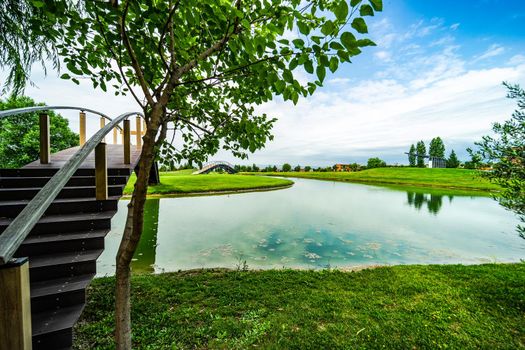 Pond with reflection in golf grassland