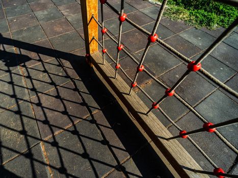 Children outdoor playground in sunny summer day with deep shadows