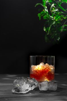 Slushies Whiskey cocktail with ice. on a black background with ice cubes.