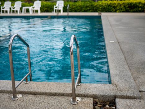 Stainless steel stairs to the pool. handrails up and down the pool.