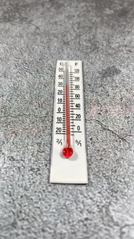 thermometer on the grey background