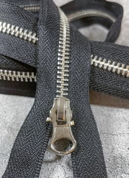black zipper on the grey background