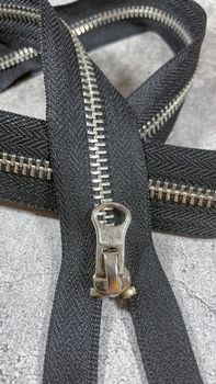 black zipper on the grey background