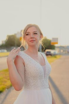 Portrait of the bride in the evening light . Wedding article. Wedding season. Choosing a wedding dress. Make-up and hairstyle for the holiday. Happy bride.