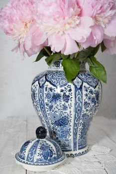 spring still life with bouquet of pink luxurious peonies in an ancient Chinese vase with blue ornament, High quality photo