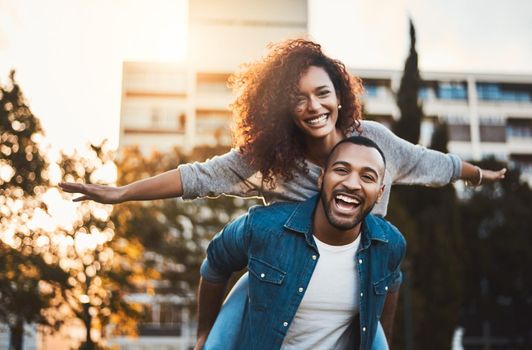 Were not letting this beautiful day go to waste. Portrait of a young couple having fun together outdoors