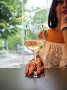 female lady having prosecco in a bar outdoors