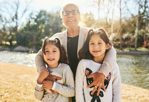 We have so much to learn from our grandmother. Portrait of a grandmother spending time with her adorable granddaughters outdoors