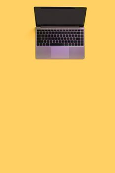 Top view of modern laptop isolated on yellow background. Copy space.