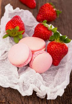 Macaroon with raspberries cookies on a wooden table