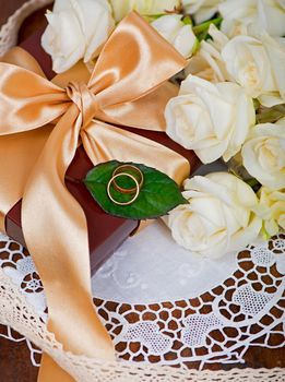 bouquet of white rose with green leaves on a wooden