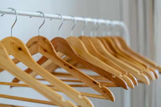 Close-up of wardrobe with wooden clothes hanger