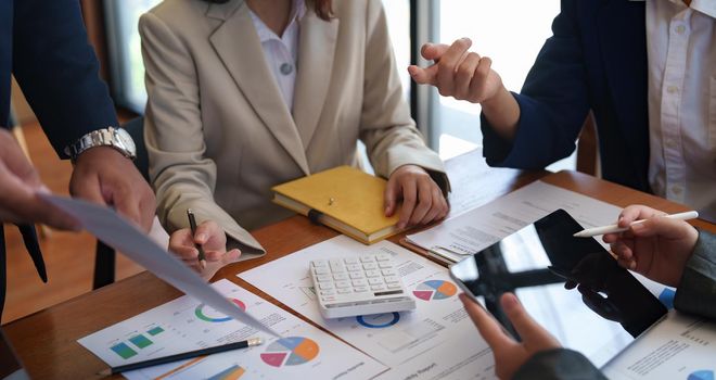 Business People Planning Strategy Analysis from Financial Paperwork Report