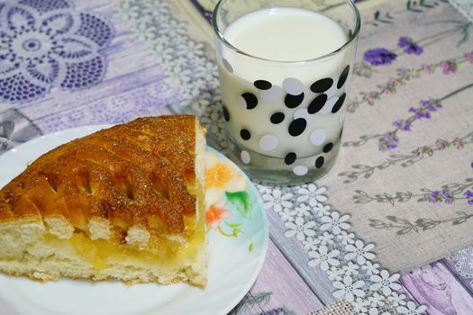 apple pie with a glass of milk on the table. photo