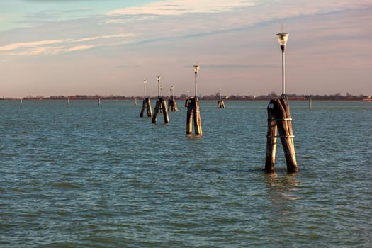 The Typical wooden poles in a Venetian lagoon, Venice