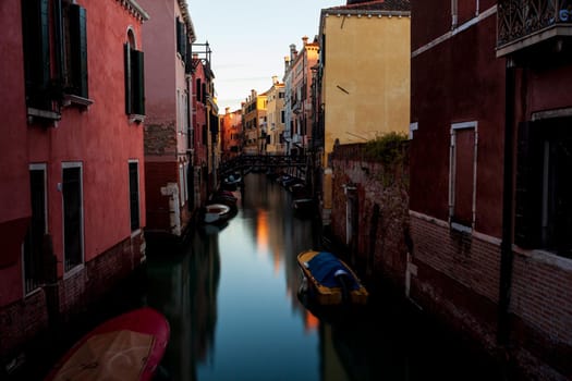 The architectural detail of an old bridge made with wooden on the typical canal in Venice