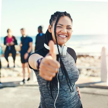 Youre well on your way to a better you. Portrait of a sporty young woman showing thumbs up while exercising outdoors