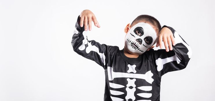 Halloween Kid. Child man horror face painting make up for ghost scary, Portrait of Asian little kid boy wearing skeleton costume studio shot isolated white background, Happy halloween day concept