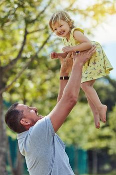 Give them wings and let them fly. a father bonding with his little daughter outdoors
