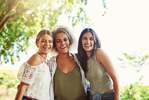 Out and about with the girls. Portrait of a group of friends bonding together outdoors