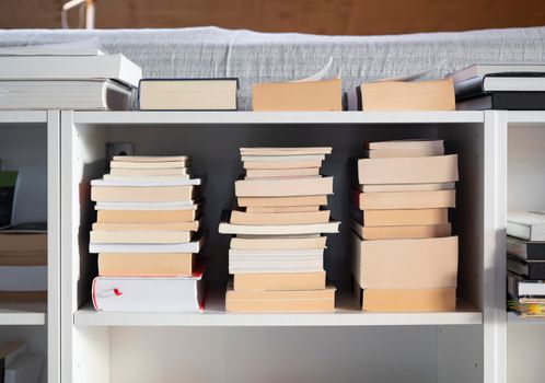 Close up of books on the shelf at home.