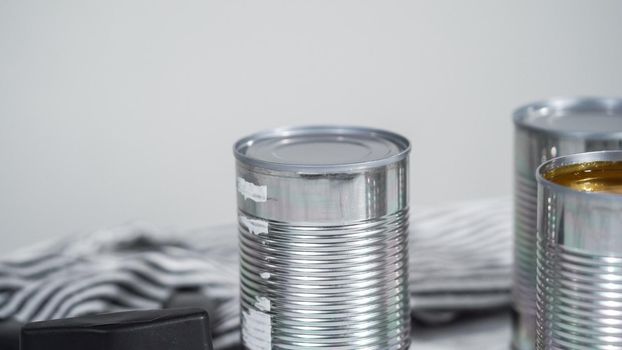 Openning canned white beans with can opener.